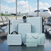 Set of light blue suitcases in an airport with an airplane in the background