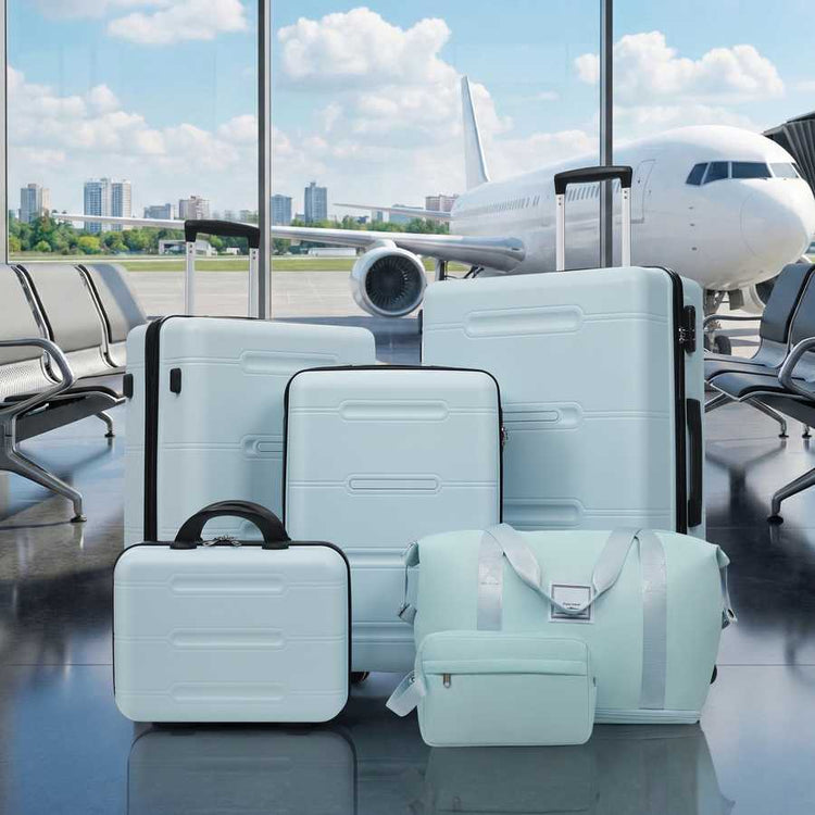 Set of light blue suitcases in an airport with an airplane in the background