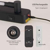 Black electronic device with USB charging port, magnetic suction, and metal baffle on a light gray background.