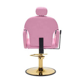 A pink salon barber chair with a matching headrest, mounted on a polished gold hydraulic pedestal base with a round black-tinted disc.