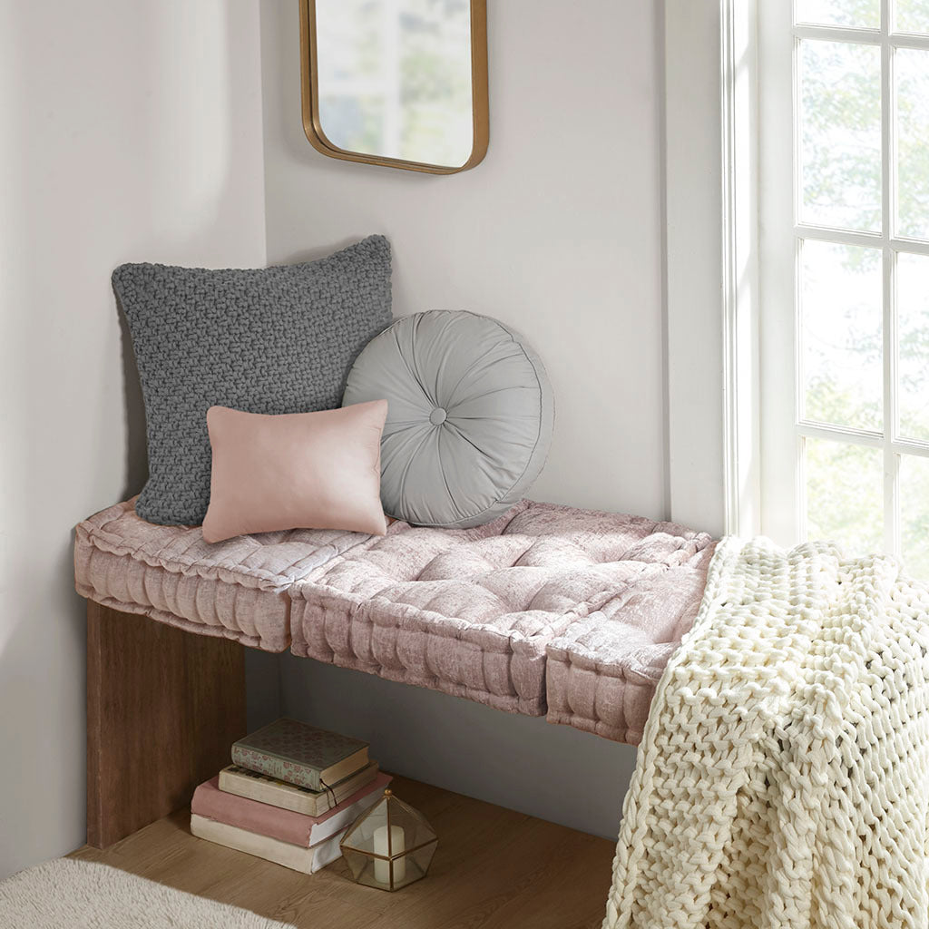 Nook with cushions and books in a bright room