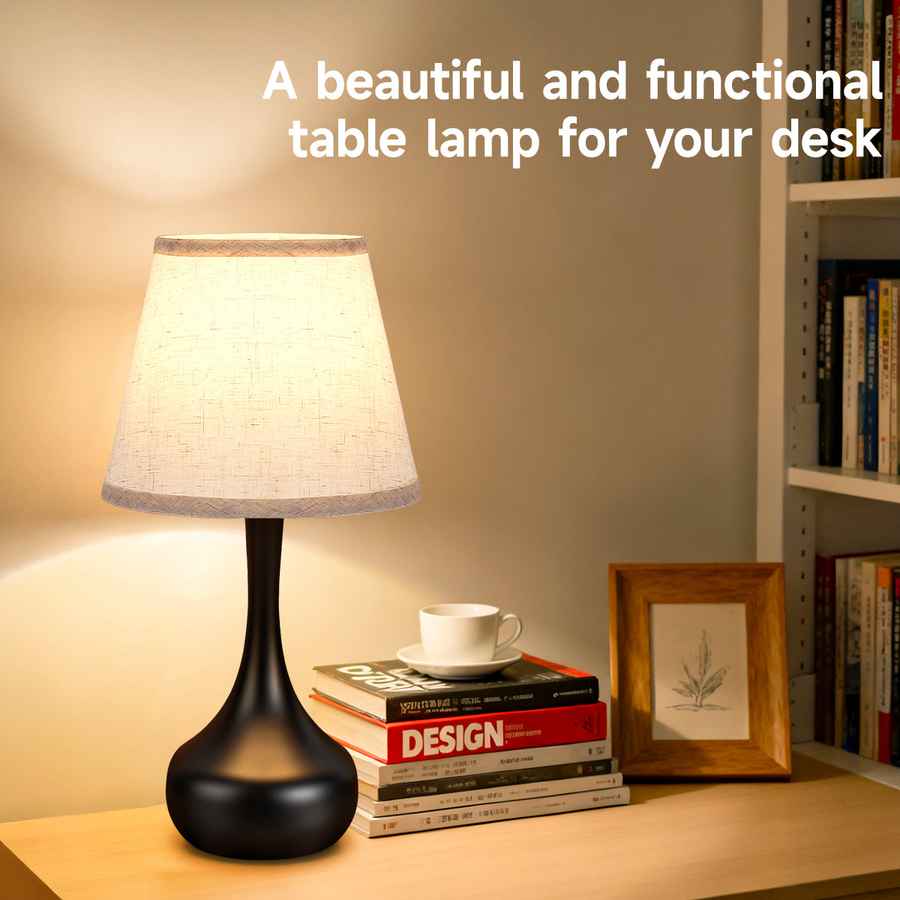 Table lamp on a desk with books and a cup, text &