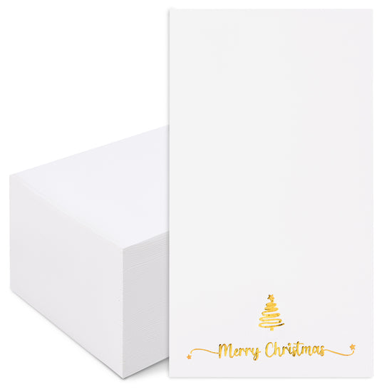 A stack of white stationery cards with a single card standing upright, featuring a small gold Christmas tree and the words &