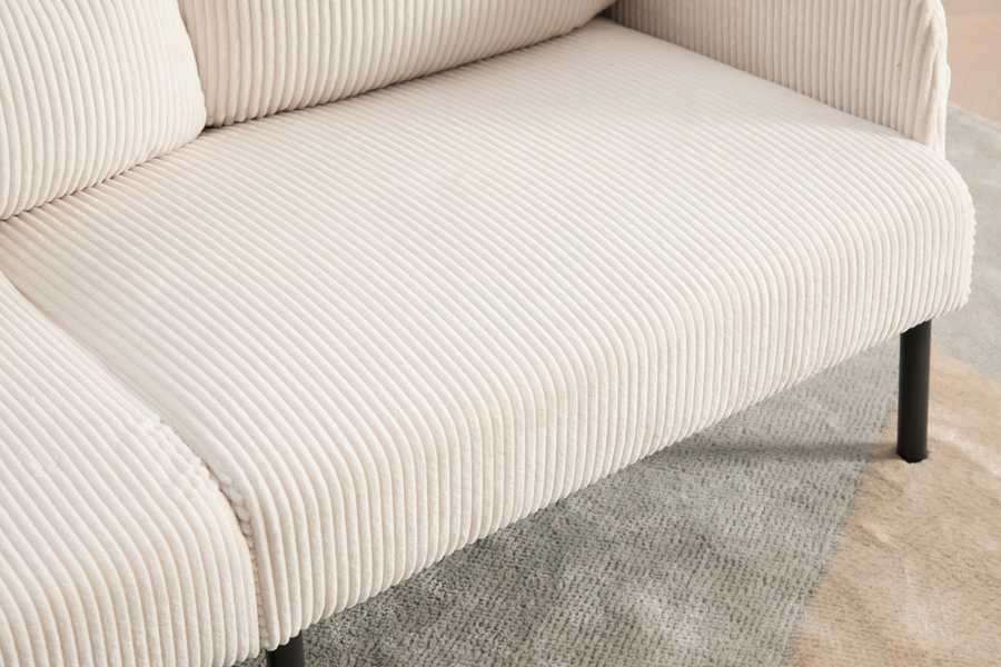 Beige corduroy sofa on a gray carpet