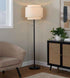 Floor lamp in a living room setting with a chair and cabinet.