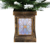 Decorative lantern with floral design under a Christmas tree