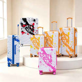Colorful set of spinner luggage suitcases in various colors including pink, blue, and orange with matching printed designs, suitable for travel.