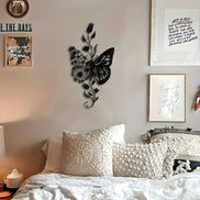 Aluminum butterfly wall art above a cozy bed with textured pillows, enhancing rustic bedroom decor.