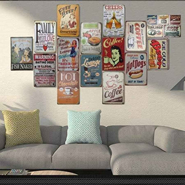 Collection of vintage-style metal signs on a wall above a sofa