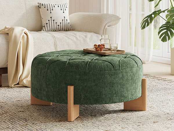 Green ottoman in a living room setting with a tray of fruit on top