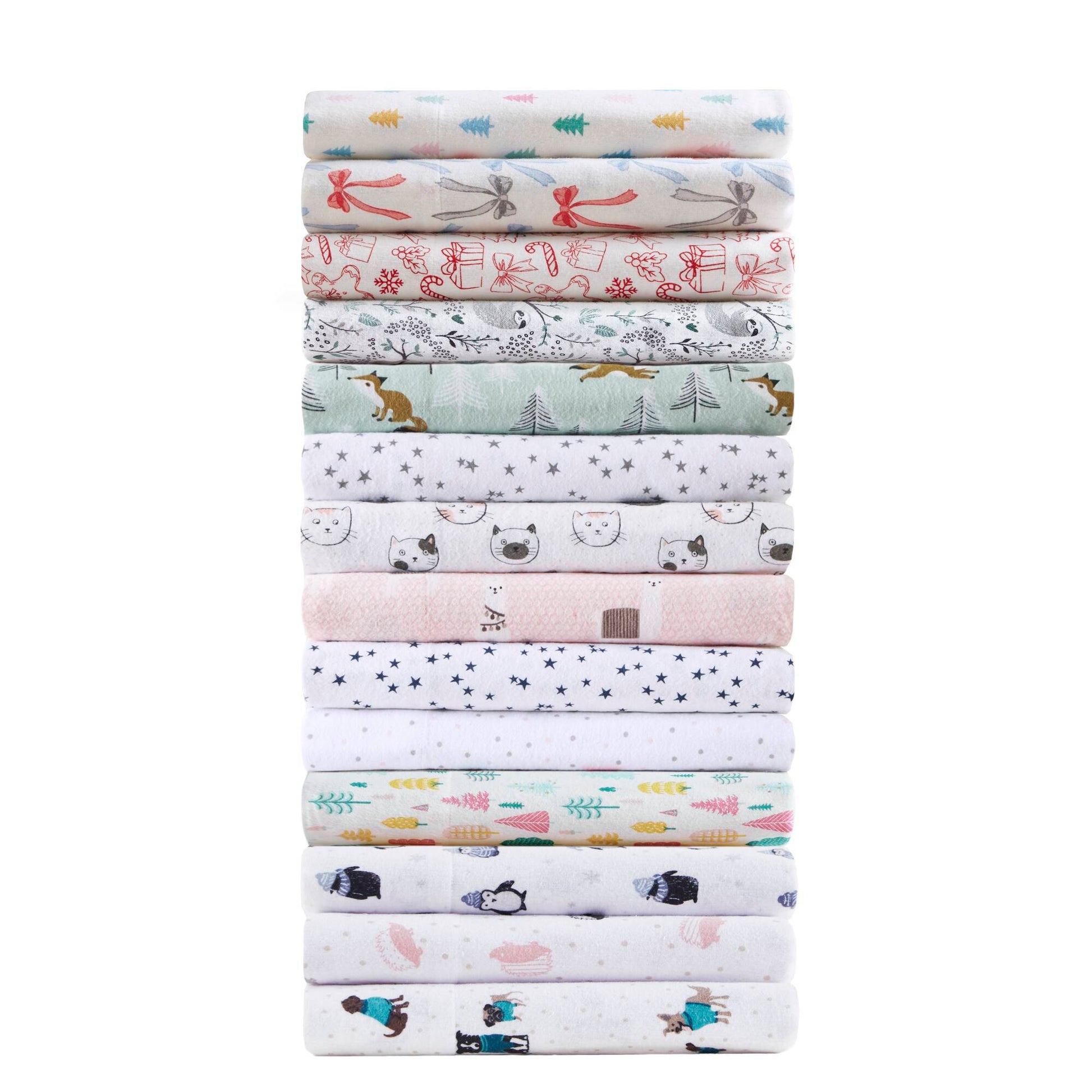 Stack of various printed cotton flannel sheet sets including Happy Bows, showcasing multiple design options for bedding.