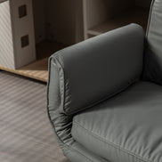 Gray cushioned chair with a blurred background