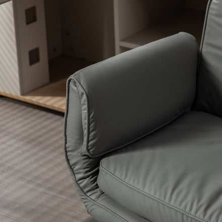 Gray cushioned chair with a blurred background