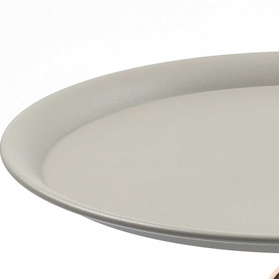 Edge detail of the Mermaid Tail Coffee Table's round grey top, emphasizing its smooth, durable finish and modern style.