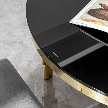 Close-up of black tempered glass tabletop on oval dining table, highlighting smooth finish and elegant design.