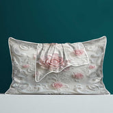 Floral patterned pillowcase with pink roses on a teal background