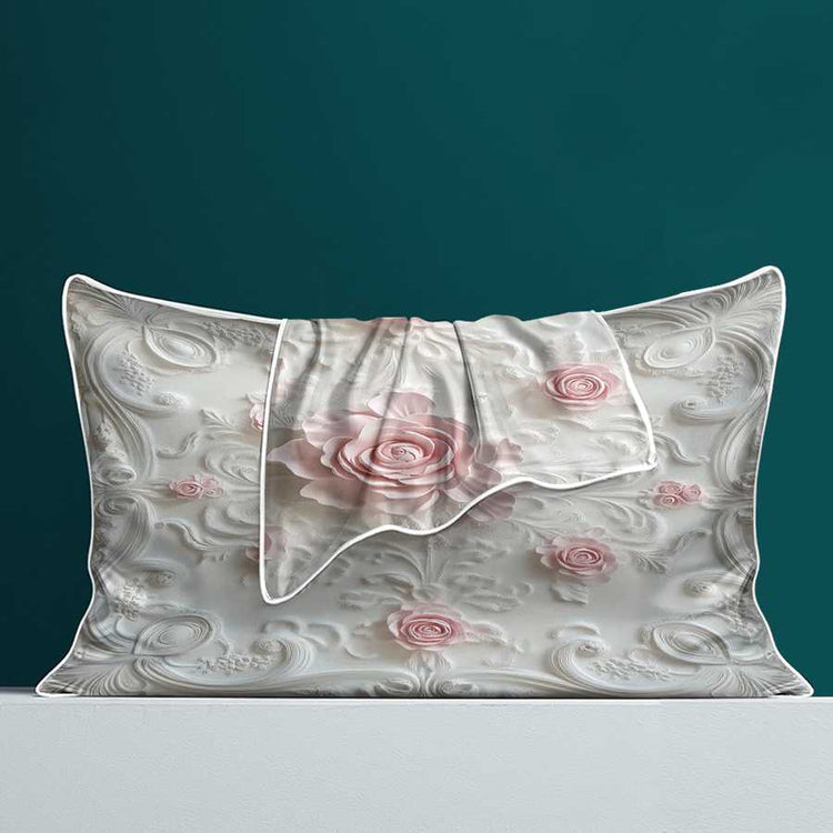 Floral patterned pillowcase with pink roses on a teal background