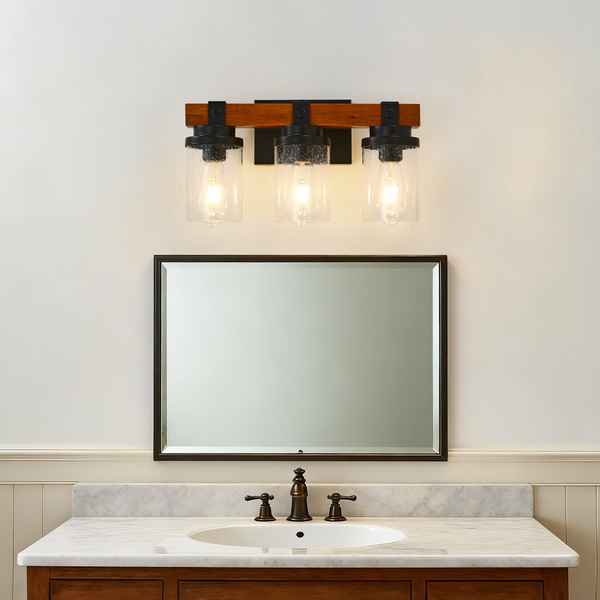 Bathroom vanity with mirror, faucet, and light fixture on a white wall.