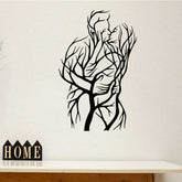 Tree of Love Wall Art featuring a couple silhouette made of tree branches, displayed above a wooden console with home decor accents.