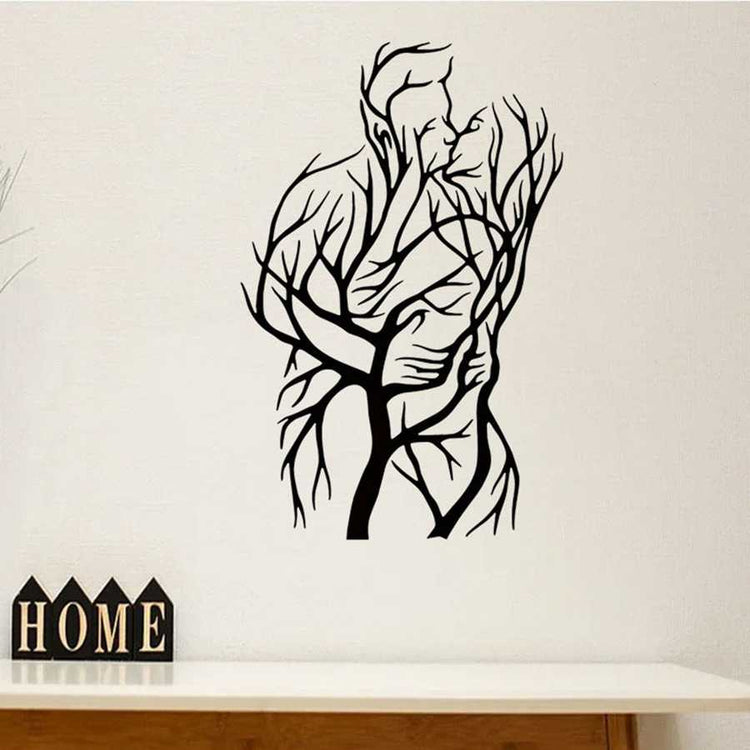 Tree of Love Wall Art featuring a couple silhouette made of tree branches, displayed above a wooden console with home decor accents.