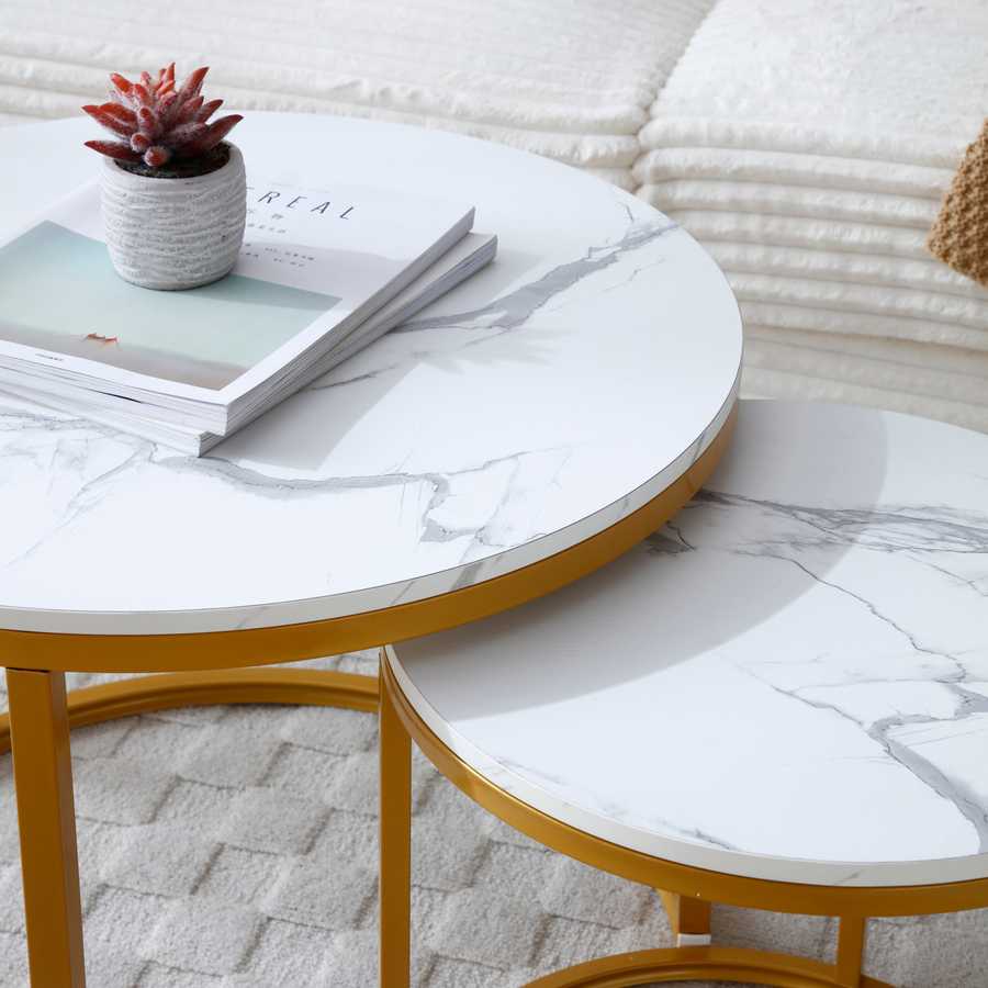 Close-up of the white gray marble-style tops on the Nesting Round Coffee Table Set, highlighting the smooth MDF surface and gold frame.