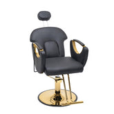 A modern barber or salon chair with black faux leather upholstery and polished gold metal accents, including the base, armrests, and headrest support, shown on a plain white background.