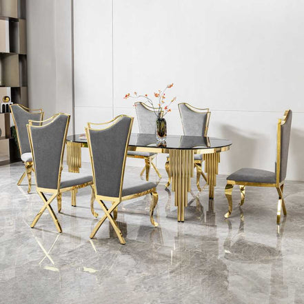 79.53 in. oval dining table with black glass top and gold legs, displayed with six gray and gold chairs in a formal dining area.
