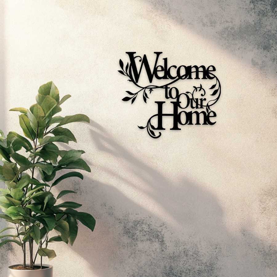 Welcome to Our Home floral wall art in black iron mounted on a textured wall, adding charm to home and garden entryway decor.