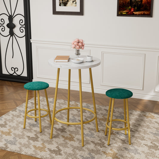 3-Piece Bar Table Set with Stools featuring a white round tabletop and gold legs, paired with green cushioned stools in a modern living space.
