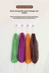 Four reusable mesh laundry bags in green, purple, orange, and brown hanging from a white rack against a light beige wall, with product feature text above.