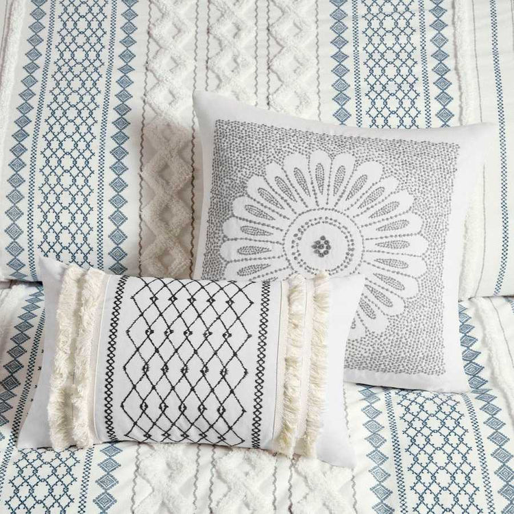 Collection of patterned pillows on a textured fabric background