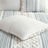 Close-up of patterned bedding with pillows on a bed