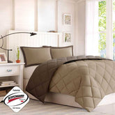 Beige quilt and pillow set on a bed in a bedroom with &