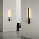 Modern wall sconces on a white wall with a minimalistic interior setting.