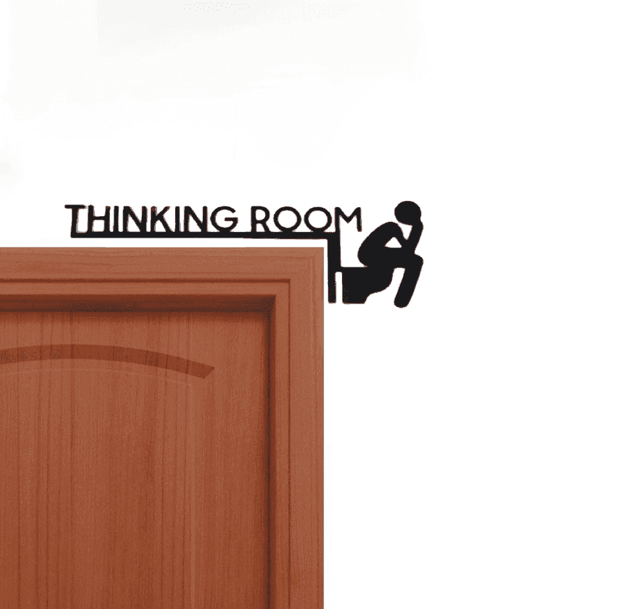 Humorous bathroom wall art metal sign with 'Thinking Room' text and figure on toilet, mounted on a wooden door frame.