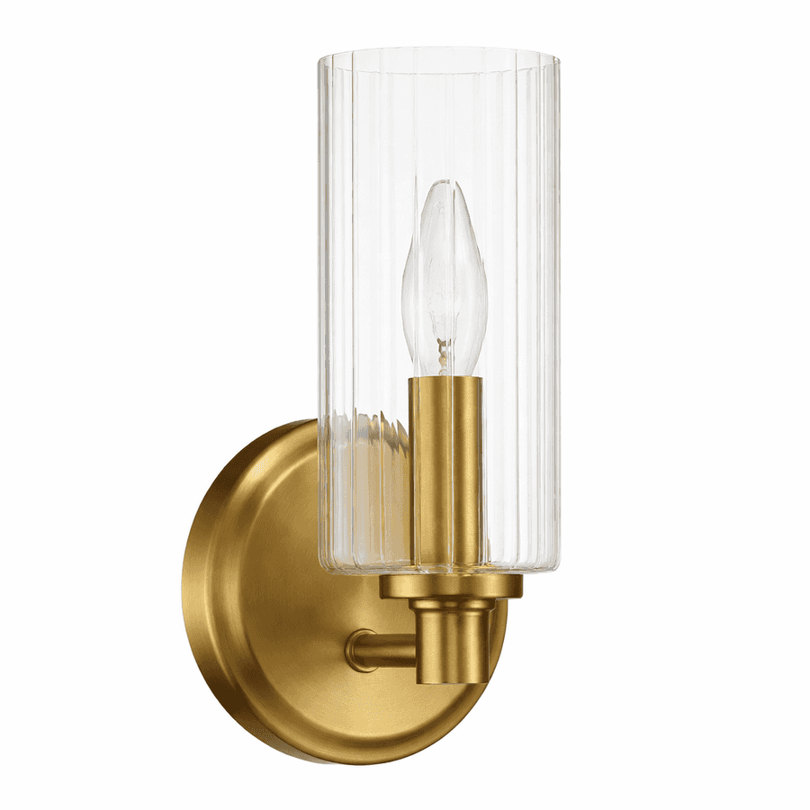Gold wall sconce with clear glass shade on a white background