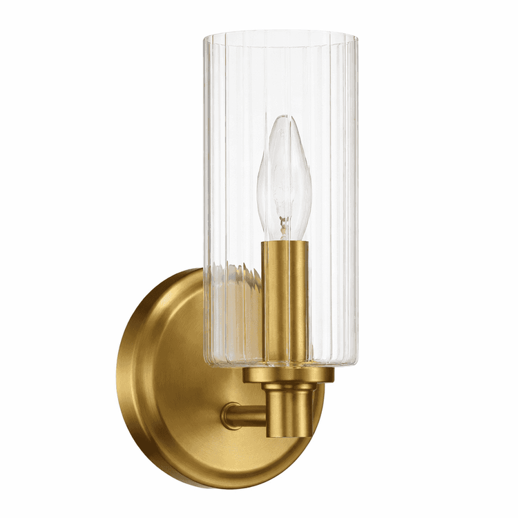 Gold wall sconce with clear glass shade on a white background