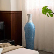 Tall 39-inch floor vase decor in blue and gray PVC placed near a window, complementing natural light and indoor plants.