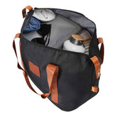 Open black travel bag filled with clothes, accessories, and toiletries, showing spacious interior for packing