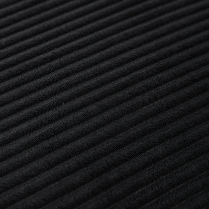 Close-up texture of black corduroy fabric on bean bag chair, highlighting soft ribbed material for stylish comfort.
