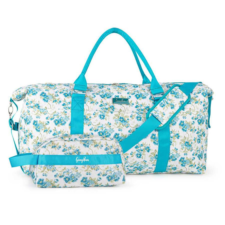 Floral duffel bag with blue straps on a white background