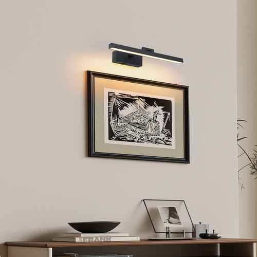 Modern wall light fixture above a framed abstract artwork on a wall.