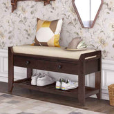Wooden bench with cushion, shoes on the shelf, and decorative pillows against floral wallpaper.