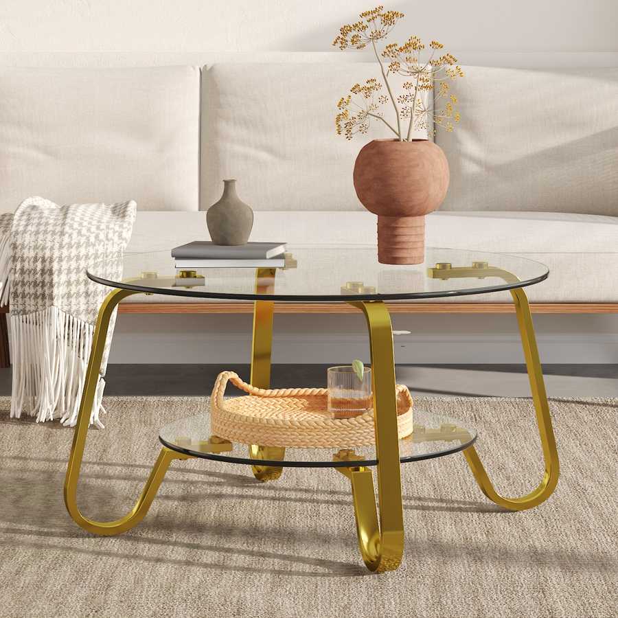Glass coffee table with vintage gold metal frame and two-tier design, complementing a minimalist white sofa.