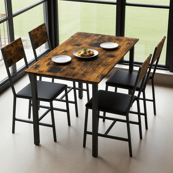 5 Piece Metal Wood Dining Table Set for 4 in a modern interior with large windows, featuring a rustic wood tabletop and black metal chairs.