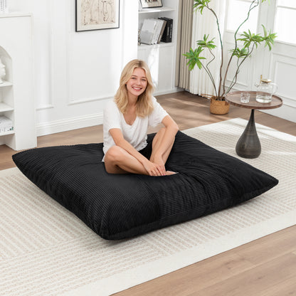 Black Corduroy Bean Bag Chair for Adults & Kids laid flat as a floor lounger, offering versatile seating in a cozy home setting.