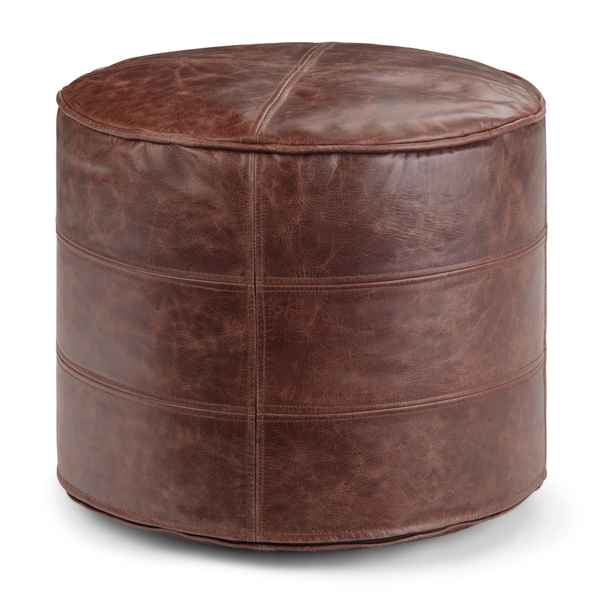 A round brown faux-leather pouf ottoman with a distressed finish, featuring horizontal stitched bands and a central seam on the top, shown on a white background.