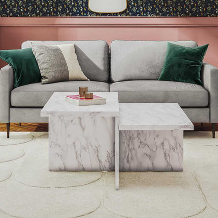 Brielle Coffee Table - Faux Marble placed in front of a gray sofa, showcasing its elegant two-tier structure and contemporary appeal.