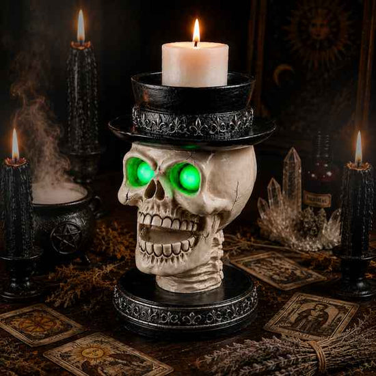 Gothic Halloween skull candle holder with glowing green LED eyes, black top hat, black and white cracked skull design, perfect for spooky home decor