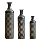Three black metal floor vases with slim necks and textured bodies, ideal for modern home decor and interior styling.